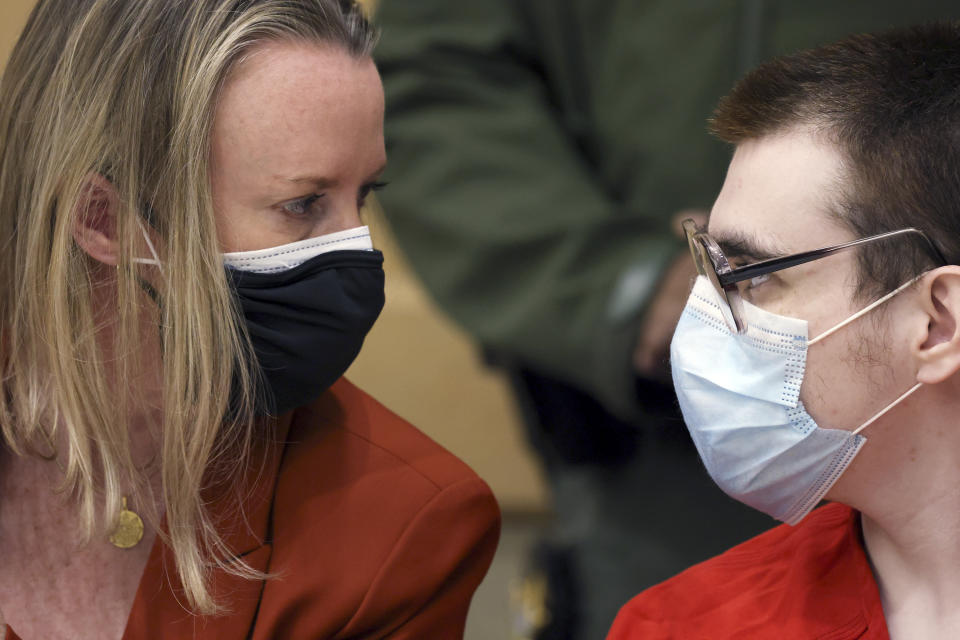 Assistant Public Defender Melisa McNeill speaks with Marjory Stoneman Douglas High School shooter Nikolas Cruz during a hearing at the Broward County Courthouse in Fort Lauderdale, Fla. on Monday, Jan. 24, 2022. (Amy Beth Bennett/South Florida Sun Sentinel via AP, Pool)