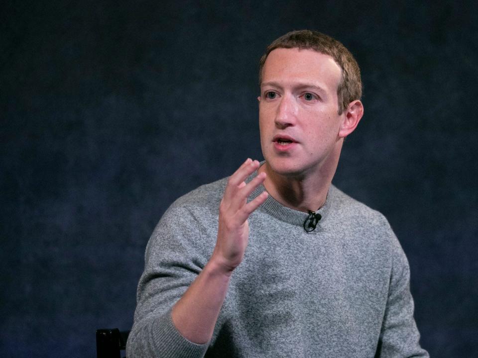 Mark Zuckerberg gestures with hand while speaking onstage