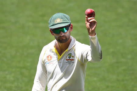 Australia's Nathan Lyon shows the ball as he leaves the field following his 6 wicket haul on day four of the first test match between Australia and India at the Adelaide Oval in Adelaide, Australia, December 9, 2018. AAP/Dave Hunt/via REUTERS