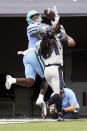 Tulane wide receiver Jha'Quan Jackson, left, makes a reception and runs 20-yards for a touchdown in front of Central Florida defensive back Aaron Robinson during the first half of an NCAA college football game, Saturday, Oct. 24, 2020, in Orlando, Fla. (AP Photo/John Raoux)