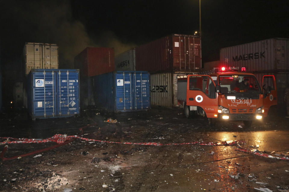 In this photo released by the Syrian official news agency SANA, shows a firefighters working at the scene of a missile attack, at the seaport of the coastal city of Latakia, Syria, Tuesday, Dec. 7, 2021. Syria’s military said Israeli warplanes fired the missiles causing fire without inflicting any human losses. Syria’s state media quoted an unnamed military official as saying that several missiles struck the containers area in the port early on Tuesday, setting some of them on fire. (SANA via AP)