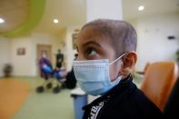 A child who suffers from cancer wears a protective mask at the Children's Hospital for Cancer Diseases in Basra