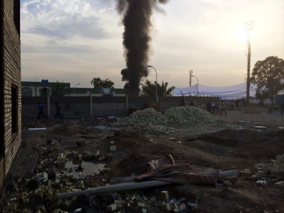 A column of smoke rises from the site where a series of bombs exploded Friday, April 25, 2014 at a campaign rally for a Shiite group in Baghdad, Iraq, killing several people and wounding nearly two dozen more. The explosions struck as some 10,000 people had gathered at the Industrial Stadium in eastern Baghdad for the Asaib Ahl al-Haq rally, in which the Shiite group planned to announce its candidates for Iraq's parliamentary election Wednesday. (AP Photo/Qassim Abdul-Zahra)