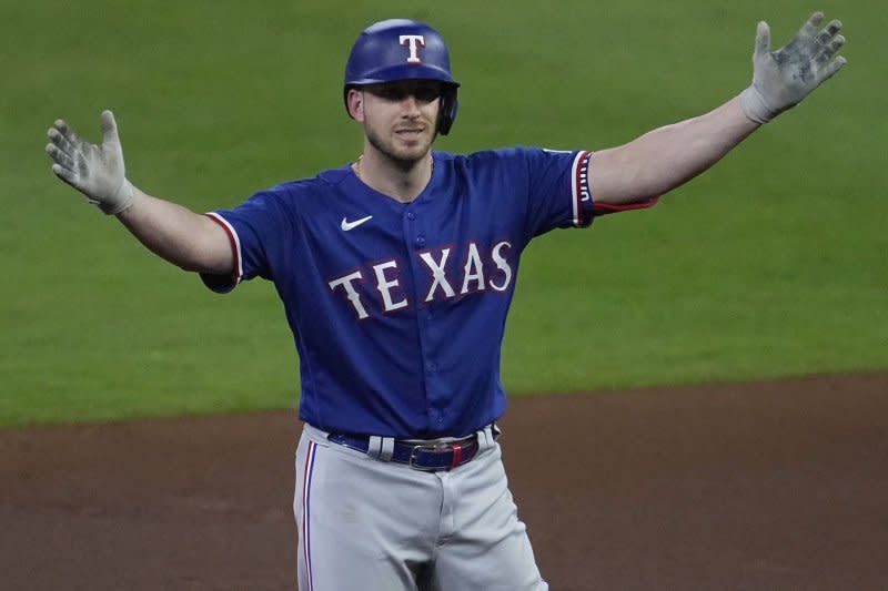Texas Rangers designated hitter Mitch Garver stands on second base after advancing from a single in the first inning against the Houston Astros in Game 7 of the ALCS on Monday at Minute Maid Park in Houston. Photo by Kevin M. Cox/UPI