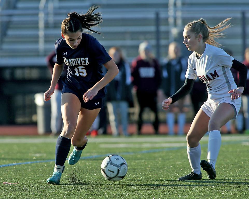 Hanover's Sophia Foley looks to get around Dedham's Lauren Pazienza during first half action of their game against Dedham in the Division 3 state final at Manning Field in Lynn on Saturday, Nov. 19, 2022. Hanover would go on to win 1-0.