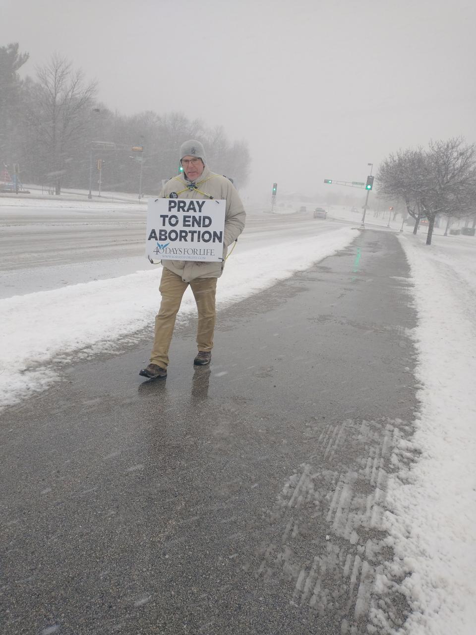 A man holds a 'Pray to End Abortion' sign on Taylor Drive, as part of the Sheboygan 40 Days for Life campaign on Ash Wednesday, as seen, Feb. 22, in Sheboygan, Wis.