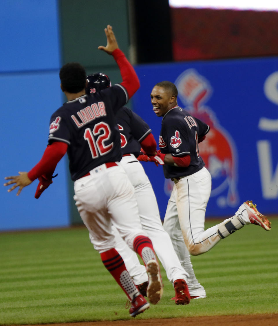 Cleveland Indians' Greg Allen, right, celebrates with teammate Yandy Diaz and Francisco Lindor (12) after his game winning single in the eleventh inning of a baseball game against the Boston Red Sox, Sunday, Sept. 23, 2018, in Cleveland. Cleveland won 4-3. (AP Photo/Tom E. Puskar)