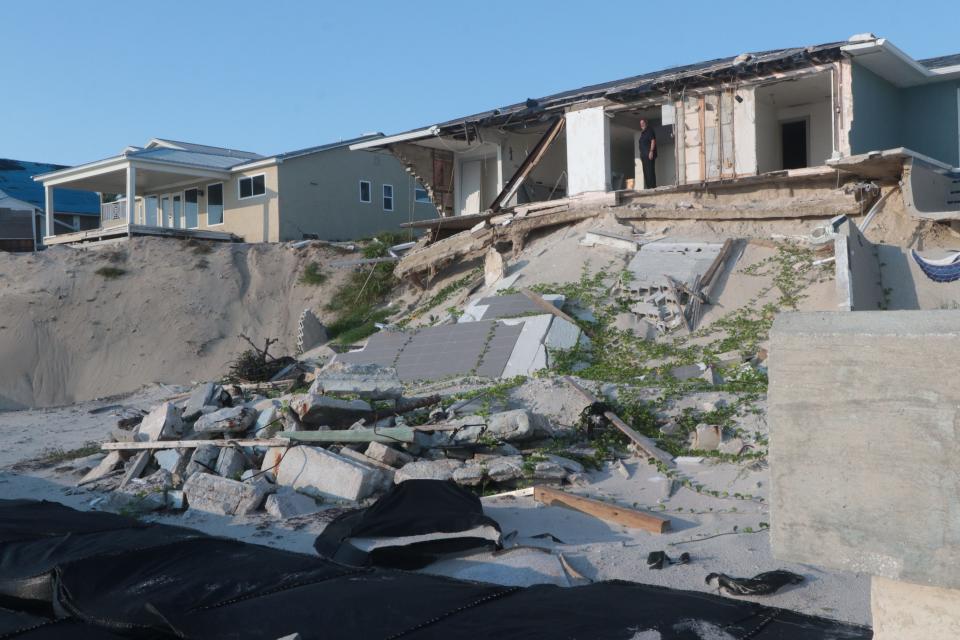 Phil Martin looks toward the Atlantic Ocean from inside one of his properties in Wilbur-by-the-Sea on Sept. 15, 2023, that was distroyed by Hurricane Ian.