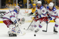 New York Rangers goaltender Igor Shesterkin (31) blocks a shot as Ryan Lindgren (55) and Morgan Barron (47) come in for the rebound in the second period of an NHL hockey game against the Nashville Predators Thursday, Oct. 21, 2021, in Nashville, Tenn. (AP Photo/Mark Humphrey)