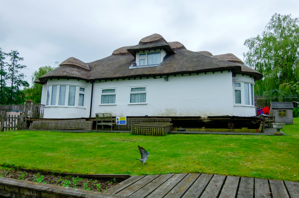 The three-bedroom house offers a large garden with a river frontage, along with allocated boat mooring and fishing opportunities (SWNS)