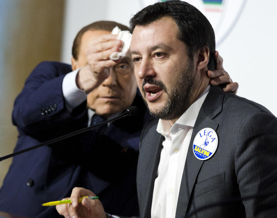 FILE - Forza Italia's Silvio Berlusconi, wipes the forehead of The League's Matteo Salvini, at a media event for center-right leaders in Rome, Thursday, March 1, 2018. With his 86th birthday on Sept. 29, and Forza Italia’s popularity shrinking in recent years, the former three-term premier is not gunning for a fourth term but instead hoping for a Senate seat. Italy will elect a new Parliament on Sept. 25. (AP Photo/Domenico Stinellis, File)