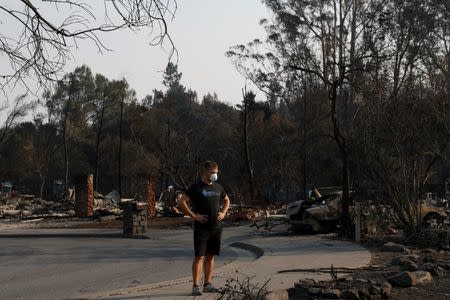 Area resident Julian Corwin stands as he surveys his neighborhood destroyed by the Tubbs Fire in Santa Rosa. REUTERS/Stephen Lam