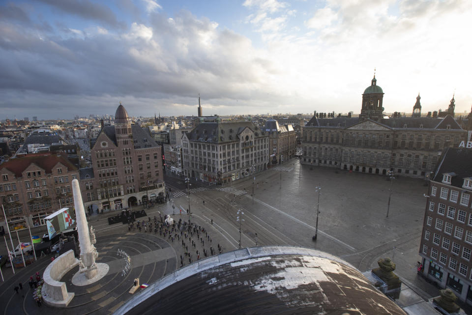 View of Dam Square devoid of spectators due to coronavirus related restrictions, as Dutch King Willem-Alexander and Queen Maxima lay a wreath during a national service to commemorate the war dead in Amsterdam, Netherlands, Tuesday, May 4, 2021. (AP Photo/Peter Dejong, Pool)