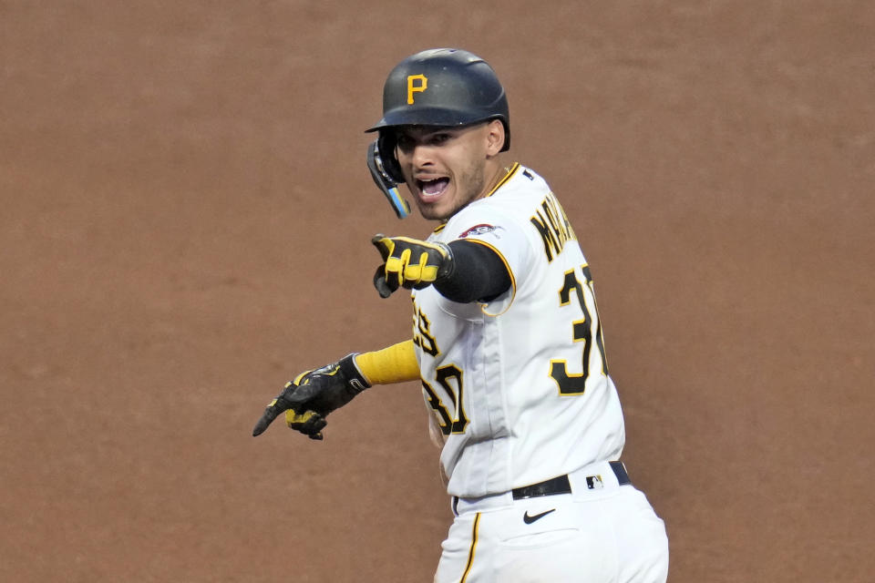 Pittsburgh Pirates' Tucupita Marcano celebrates as he rounds first base after hitting a grand slam home run off Texas Rangers relief pitcher Joe Barlow during the seventh inning of a baseball game in Pittsburgh, Monday, May 22, 2023. (AP Photo/Gene J. Puskar)