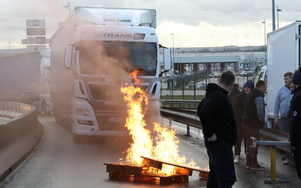 French fishermen block trucks at the Eurotunnel Freight Terminal during a day of protests to mark their anger over the issue of - REUTERS