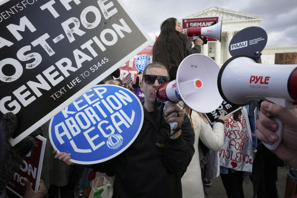 FILE - An abortion rights protestor, center, uses a megaphone as anti-abortion demonstrators rally outside the U.S. Supreme Court during the March for Life, Friday, Jan. 20, 2023, in Washington. (AP Photo/Alex Brandon, File)