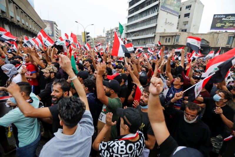 Demonstrators shout slogans during a protest over corruption, lack of jobs, and poor services, in Baghdad