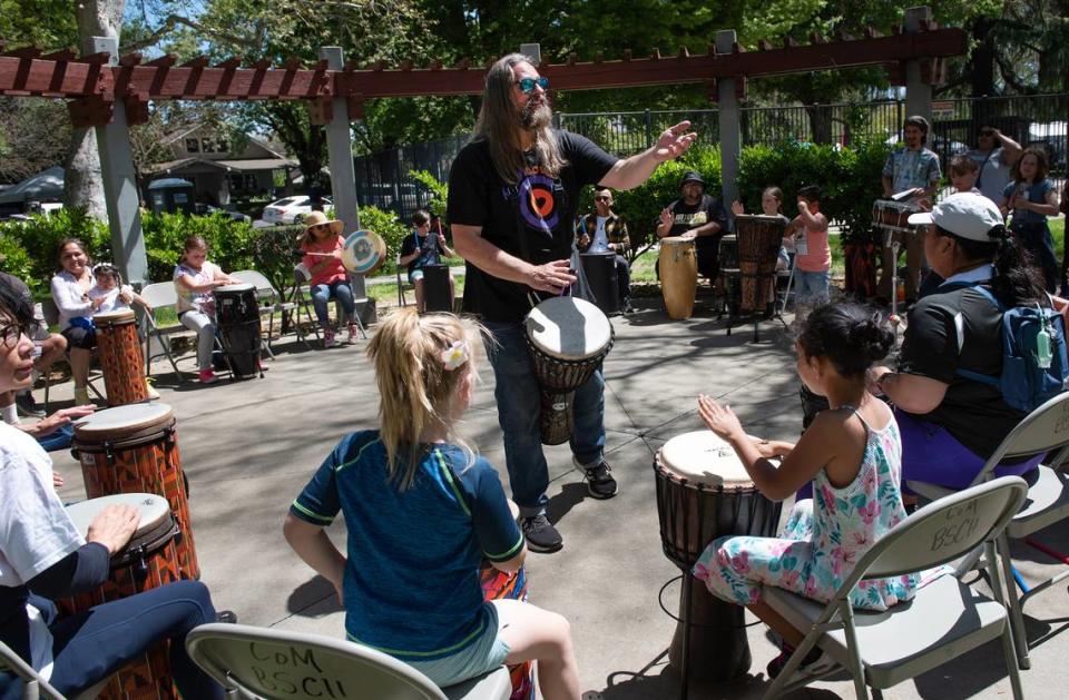 A drum circle is hosted by Drum Love during the Earth Day celebration at Graceada Park in Modesto, Calif., Saturday, April 22, 2023.