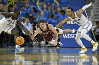 UCLA forward Adem Bona, left, vies for a loose ball with guard Amari Bailey, right, against Bellarmine guard Peter Suder during the second half of an NCAA college basketball game in Los Angeles, Sunday, Nov. 27, 2022. (AP Photo/Alex Gallardo)