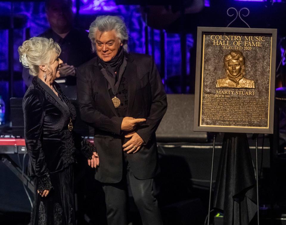 Connie Smith and Marty Stuart react as Stuart's Country Music Hall of Fame plaque is revealed during the Medallion Ceremony Sunday, November 21, 2021.