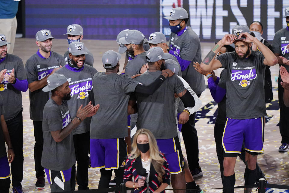 The Los Angeles Lakers celebrate after beating the Denver Nuggets in an NBA conference final playoff basketball game Saturday, Sept. 26, 2020, in Lake Buena Vista, Fla. The Lakers won 117-107 to win the series 4-1. (AP Photo/Mark J. Terrill)