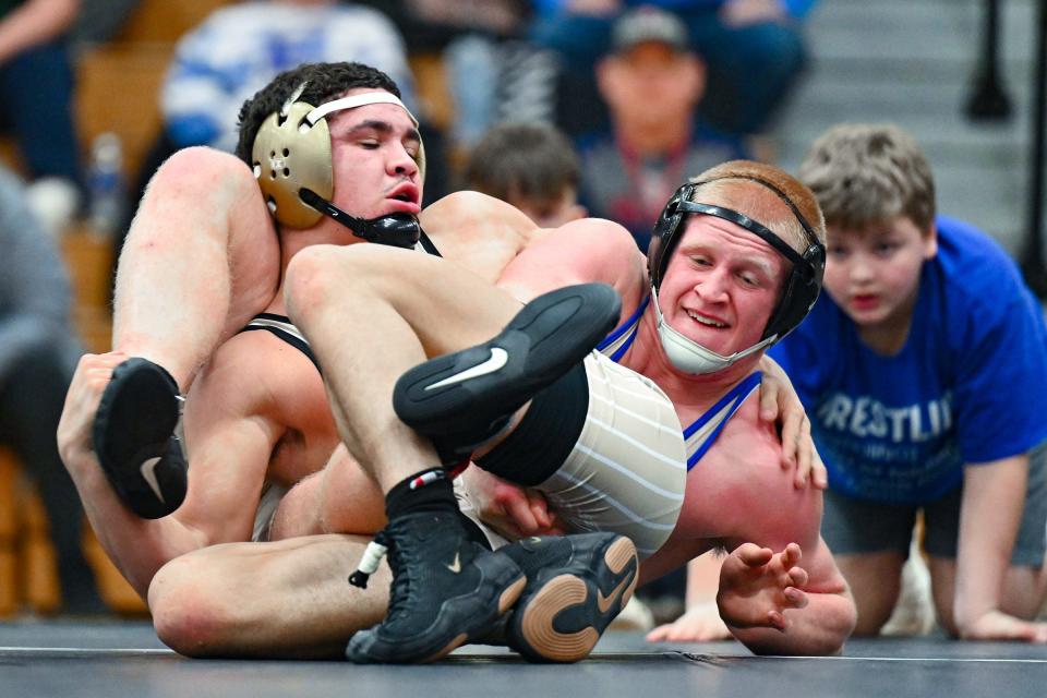 Penn’s Zymarion Hollyfield, left, and Elkhart’s Ethan Freedline wrestle in the 170-pound Northern Indiana Conference championship Saturday, Jan. 14, 2023, at Elkhart High School. Hollyfield won.