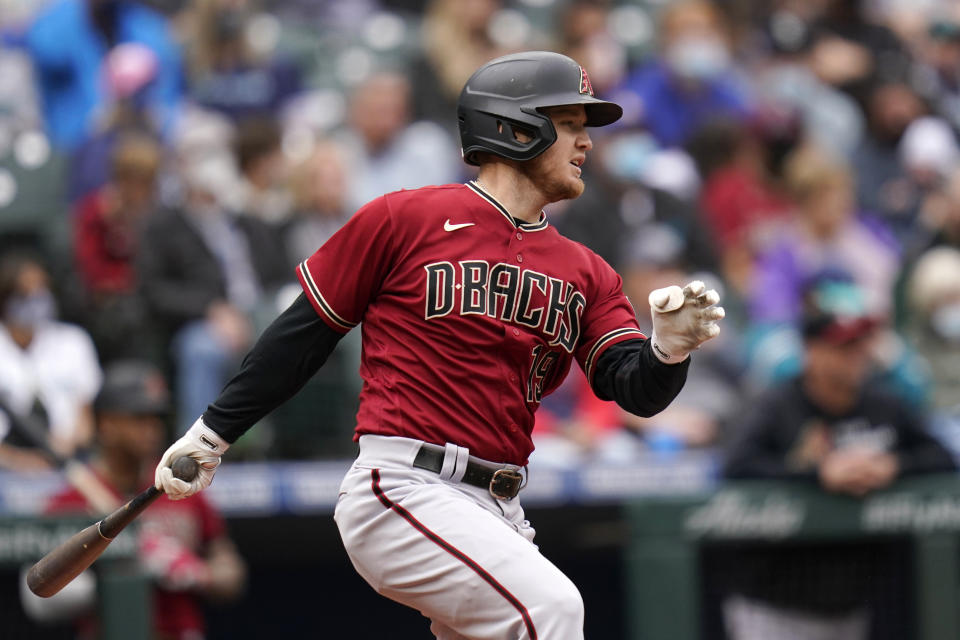 Arizona Diamondbacks' Josh VanMeter singles to drive in a run against the Seattle Mariners in the third inning of a baseball game Sunday, Sept. 12, 2021, in Seattle. (AP Photo/Elaine Thompson)