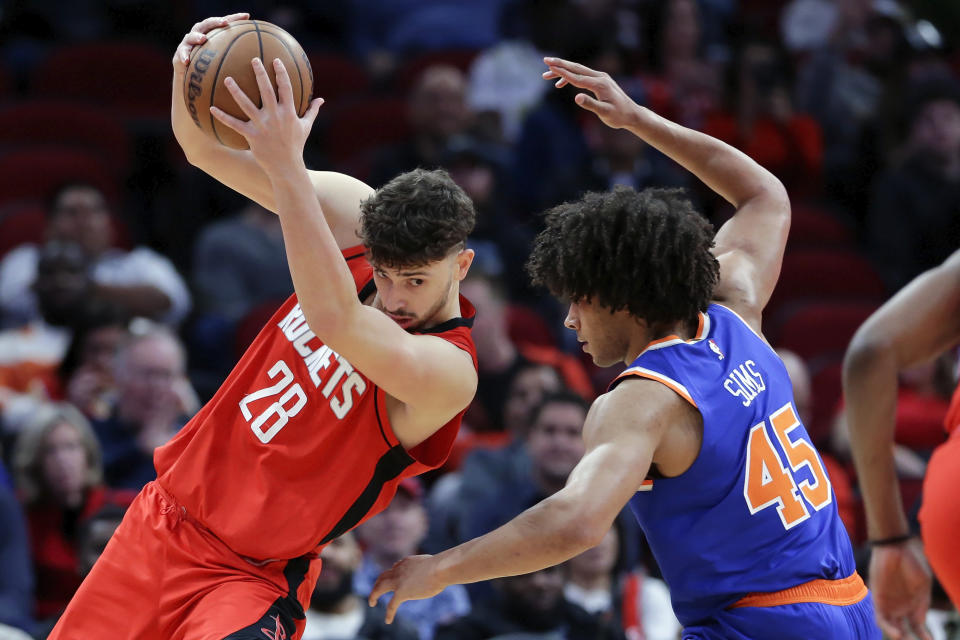 Houston Rockets center Alperen Sengun (28) maneuvers to get around New York Knicks center Jericho Sims (45) during the first half of an NBA basketball game Monday, Feb. 12, 2024, in Houston. (AP Photo/Michael Wyke)