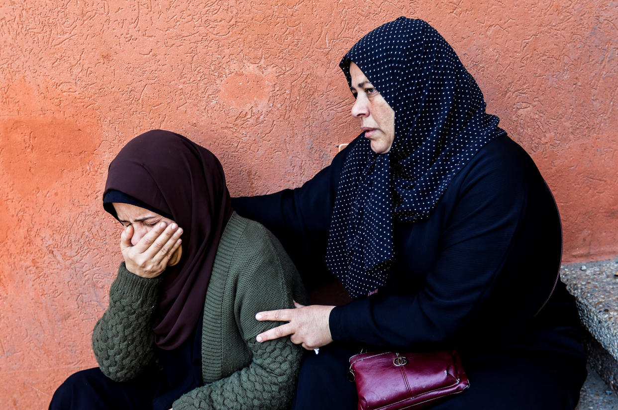 Women mourn during a funeral for Palestinians killed in Israeli strikes, amid the ongoing conflict between Israel and Palestinian Islamist group Hamas, during a funeral at Nasser hospital in Khan Younis in the southern Gaza Strip, December 9, 2023. REUTERS/Ibraheem Abu Mustafa