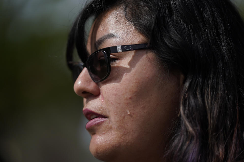 In this Monday, March 20, 2023, photo in Chandler, Ariz, Vanessa Martinez cries as she recounts the day her ex-boyfriend broke into her condo and shot her. After leaving the hospital, she applied for victim compensation but was denied because she had outstanding court fines from unrelated incidents. (AP Photo/Ashley Landis)