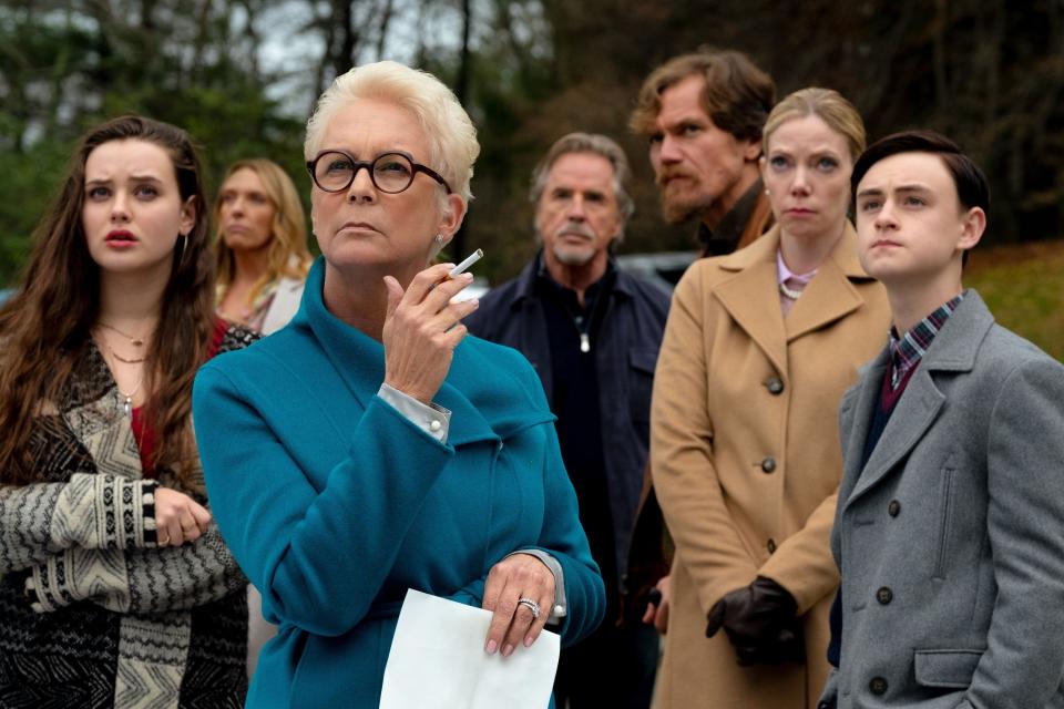 Jamie Lee Curtis, Chris Evans, Ana de Armas, Michael Shannon, Don Johnson, and Katherine Langford stand outside, looking serious and attentive