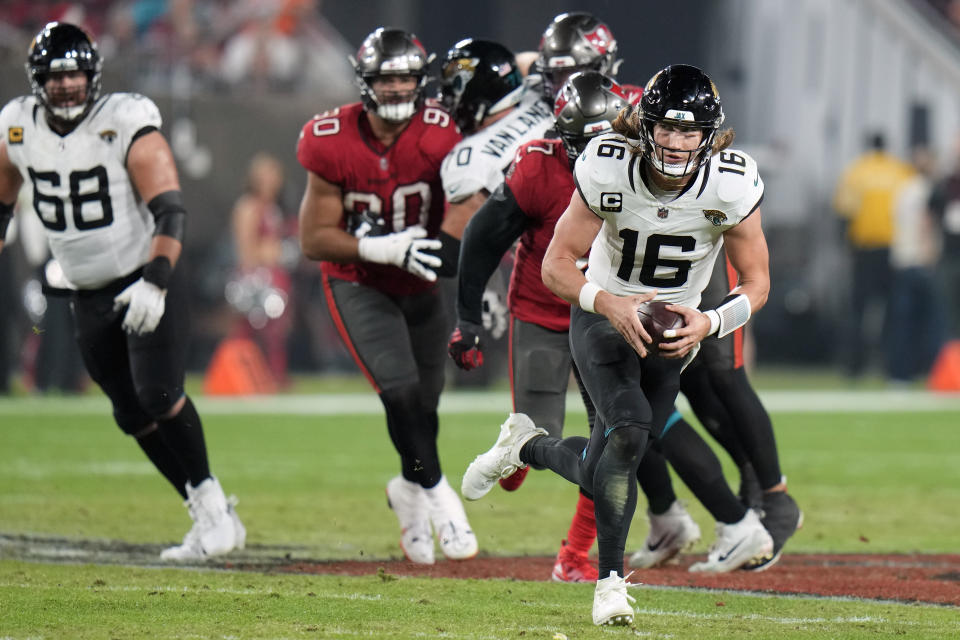 Jacksonville Jaguars quarterback Trevor Lawrence (16) scrambles for a first down against the Tampa Bay Buccaneers during the second half of an NFL football game Sunday, Dec. 24, 2023, in Tampa, Fla. (AP Photo/Chris O'Meara)