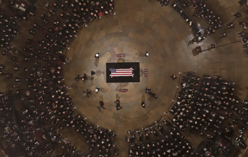 They Bush family walks past the casket of former President George H.W. Bush has he lies in state in the U.S. Capitol Rotunda Monday, Dec. 3, 2018, in Washington. (AP Photo/Morry Gash via AP, Pool)