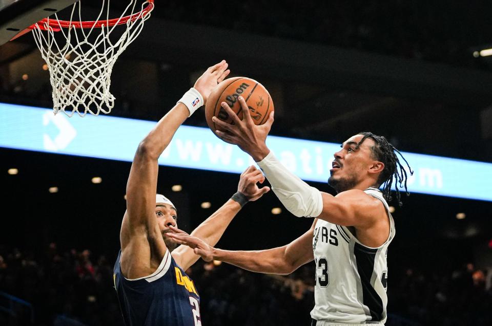 San Antonio Spurs guard Tre Jones (33) drives up to the hoop as Denver Nuggets forward Zeke Nnaji (22) defends in the second quarter of the Spur's I-35 series game at the Moody Center in Austin, Friday March 15, 2024. The Spurs lost to the Denver Nuggets 106-117.