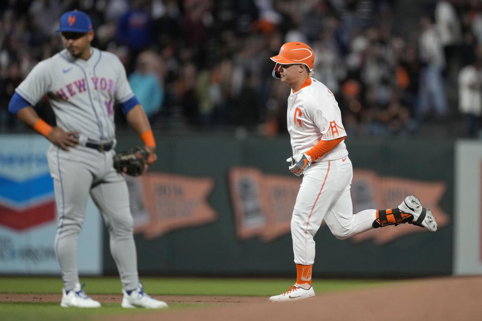 San Francisco Giants' Joc Pederson, right, runs the bases on a two-run home run, as New York Mets third baseman Eduardo Escobar looks away during the fifth inning of a baseball game in San Francisco, Tuesday, May 24, 2022. (AP Photo/Tony Avelar)