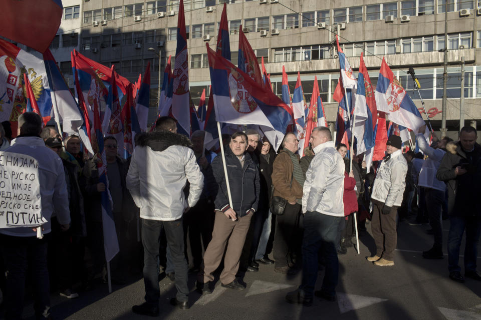 Supporters of Russia's president Vladimir Putin and his Serbian counterpart Aleksandar Vucic hold Serbian flags during a gathering in Belgrade, Serbia, Thursday, Jan. 17, 2019. Amid a lavish welcome, Putin arrived in Serbia on Thursday in a show of the Russian president's support for the Balkan country's populist leader and his pro-Moscow policies. (AP Photo/Marko Drobnjakovic)