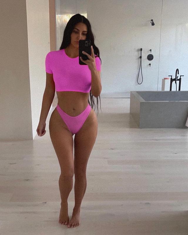 Kim Kardashian Poses in a Hot Pink SKIMS Two-Piece Featuring a Crop Top and  High-Waisted Bottoms