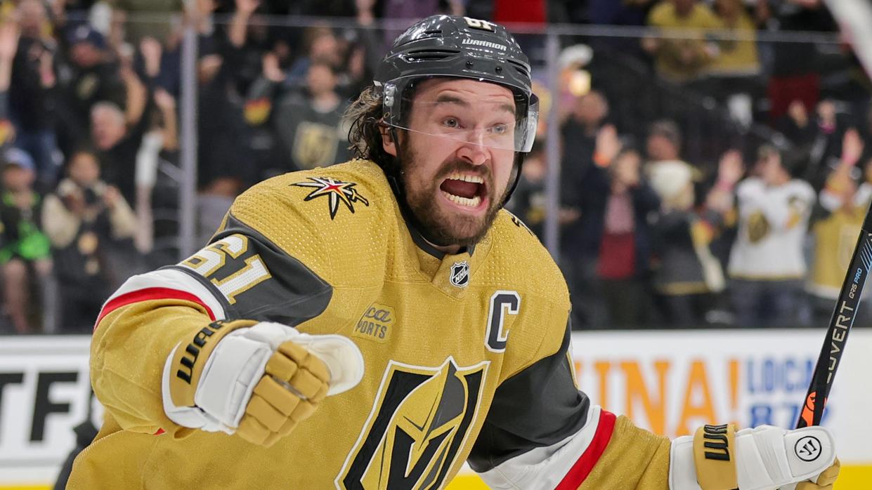   Mark Stone #61 of the Vegas Golden Knights celebrates after assisting teammate Brett Howden #21 on the game-winning goal against the Dallas Stars in overtime 