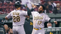 Oakland Athletics' Matt Olson, left, is congratulated by Elvis Andrus (17) after his solo home run off Boston Red Sox starting pitcher Eduardo Rodriguez during the sixth inning of a baseball game, Wednesday, May 12, 2021, in Boston. (AP Photo/Charles Krupa)