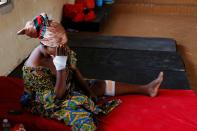 Nancy Nyarko, 51, sits at a shelter for displaced survivors after receiving medical attention for wounds suffered when a vehicle carrying mining explosives detonated along a road in Apiate near Bogoso,