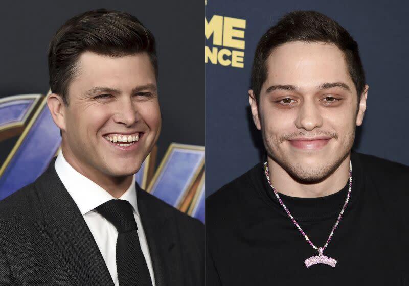 Colin Jost on the left wearing a black suit and tie, Pete Davidson on the right wearing a black shirt and a necklace