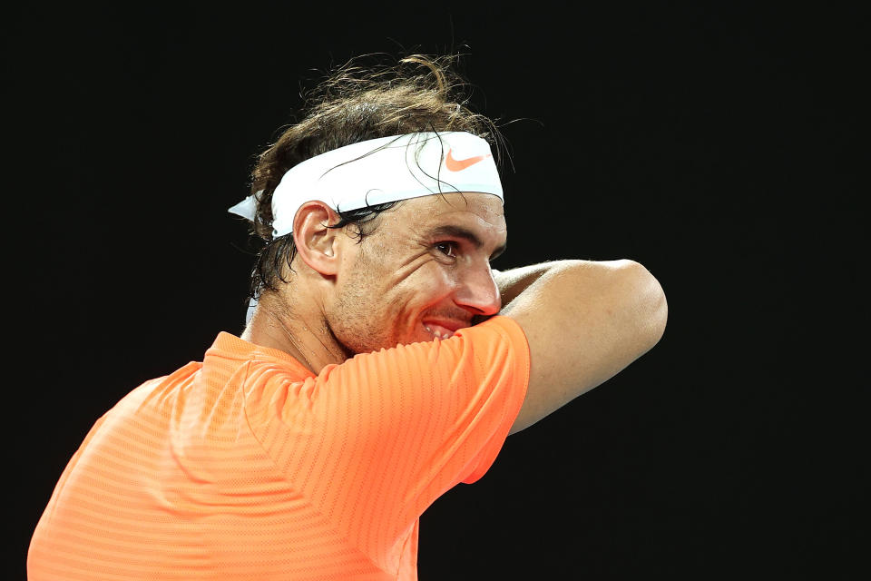 MELBOURNE, AUSTRALIA - FEBRUARY 11: Rafael Nadal of Spain laughs at a spectator in his Men's Singles second round match against Michael Mmoh of the United States during day four of the 2021 Australian Open at Melbourne Park on February 11, 2021 in Melbourne, Australia. (Photo by Cameron Spencer/Getty Images)