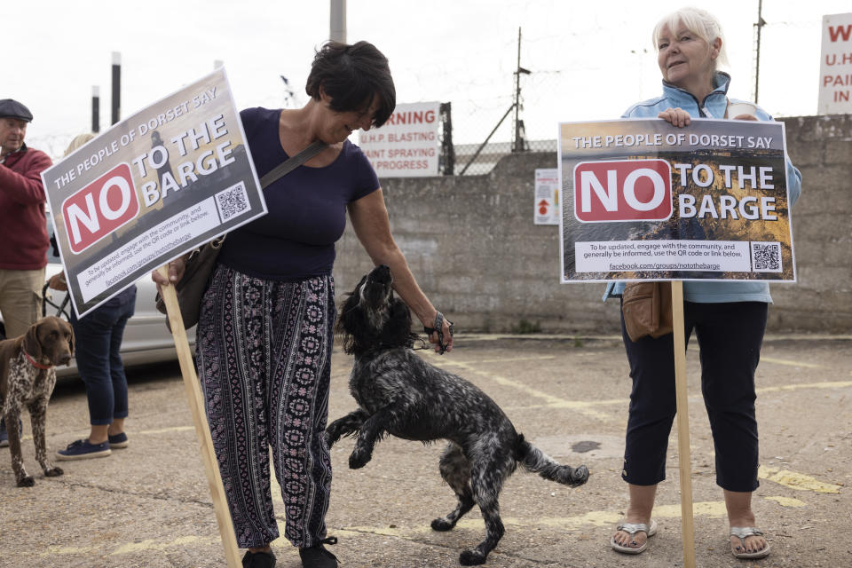 PORTLAND, ENGLAND - JULY 18: Portland residents stage a small protest outside the port entrance as the Bibby Stockholm migrant barge arrives at Portland Harbour on July 18, 2023 in Portland, England. The Bibby Stockholm arrives in Portland, after a refit at Falmouth, to serve as living quarters for up to 500 asylum seekers to the UK. (Photo by Dan Kitwood/Getty Images)