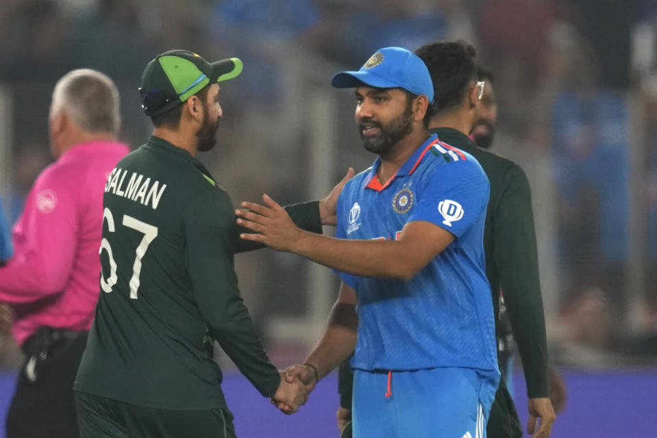 India's captain Rohit Sharma shakes hands with Pakistan's Pakistan's Salman Agha following India's win in the ICC Men's Cricket World Cup match between India and Pakistan in Ahmedabad, India, Saturday, Oct. 14, 2023.(AP Photo/Rajanish Kakade)