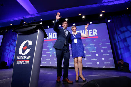 Conservative leadership candidate Andrew Scheer and his wife Jill wave on stage at the Conservative Party of Canada leadership convention in Toronto, Ontario, Canada, May 26, 2017. REUTERS/Chris Wattie