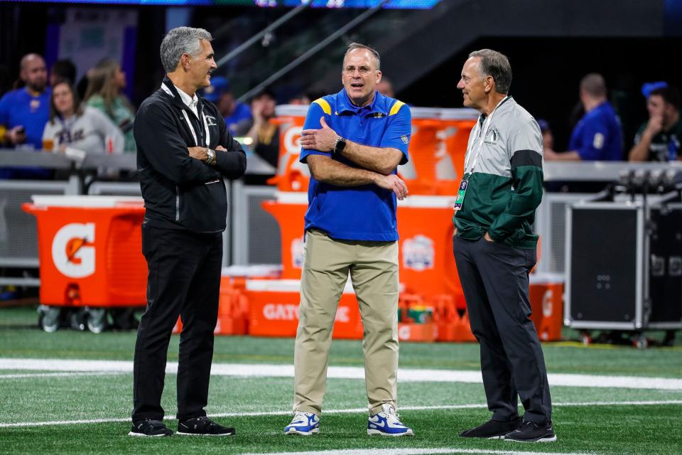 Former Michigan State coach Mark Dantonio, right, talks to Pittsburgh coach Pat Narduzzi, center, during warmups before the Peach Bowl at the Mercedes-Benz Stadium in Atlanta on Thursday, Dec. 30, 2021.