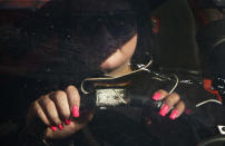 Rookie race driver Chelsey O'Reilly,14, sports her good luck pink fingernails while waiting to take part in qualifying in the Streets stock car category at Agassiz Speedway in Agassiz, British Columbia July 7, 2012. Although Chelsey had driven the car on the track before, she had to wait until turning the minimum 14 years old before the strict course rules allowed her to compete. Picture taken July 7, 2012. REUTERS/Andy Clark (CANADA - Tags: SOCIETY SPORT MOTORSPORT) ATTENTION EDITORS - PICTURE 06 OF 25 FOR PACKAGE 'HIGH OCTANE AND A PRINCESS'