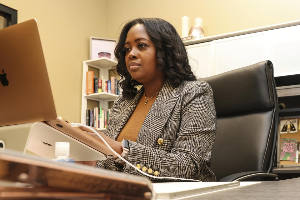 Moné Holder, senior director of advocacy and programs for Florida Rising, works at her desk in Jacksonville, Fla., Jan. 17, 2023. A protracted legal fight over how city council districts were drawn in Jacksonville, Florida, reflects an aspect of redistricting that often remains in the shadows. Political map-drawing for congressional and state legislative seats captures wide attention after new census numbers are released every 10 years. No less fierce are the battles over the way voting lines are drawn in local governments, for city councils, county commissions and even school boards. (AP Photo/Gary McCullough)