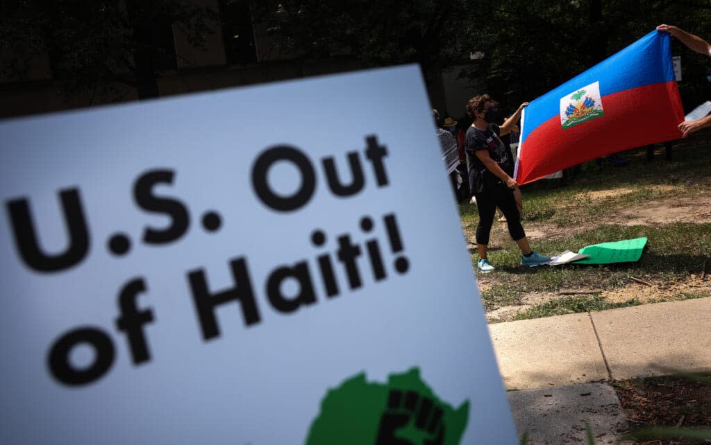 Activists with Black Alliance For Peace hold a rally against U.S. intervention in Haiti in the wake of the assassination of Haitian President Jovenel Moise, outside of the U.S. State Department on July 15, 2021 in Washington, DC. The group argues that foreign aid and involvement will hinder the Haitian people’s right for self-determination and popular democracy. (Photo by Kevin Dietsch/Getty Images)