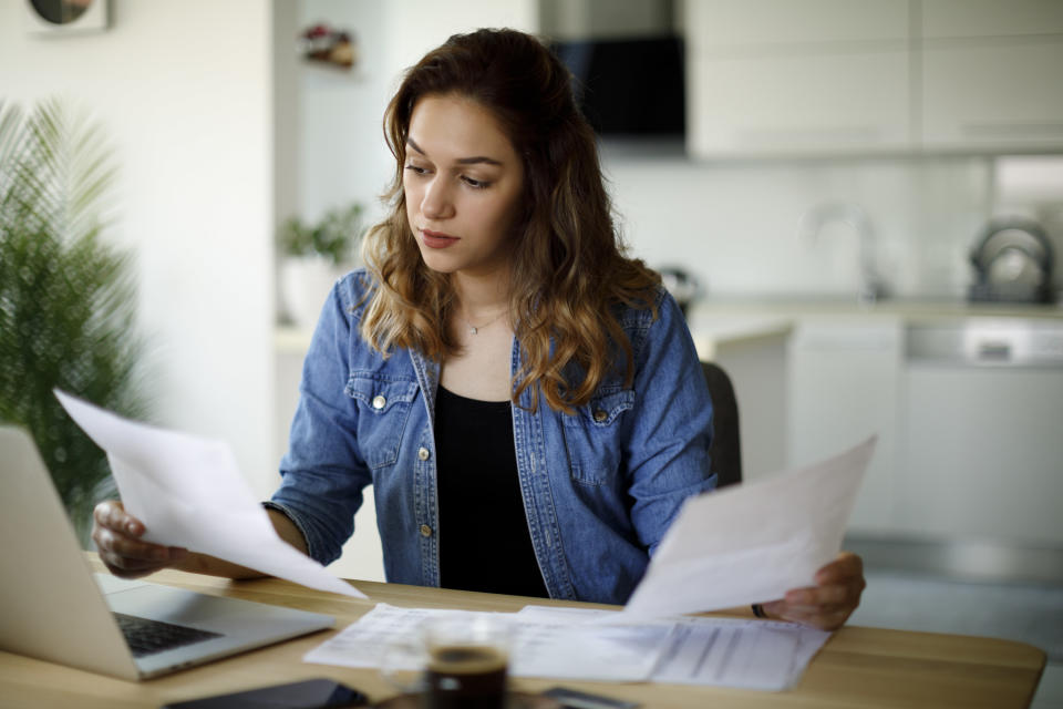 Woman looking at papers from her home